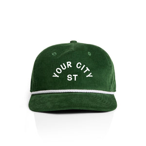 Customizable green corduroy cap with 'YOUR CITY STATE' text on a white background