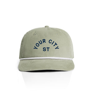 Customizable green corduroy cap with 'YOUR CITY STATE' text on a white background