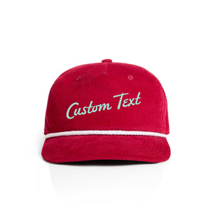 Red corduroy cap with 'Custom Text' in seaglass on a white background