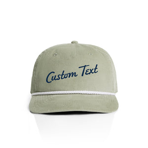 Pistachio green corduroy cap with 'Custom Text' in navy on a white background