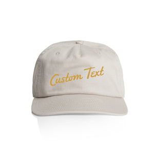 Customizable off white cap with 'Custom Text' in yellow on a white background