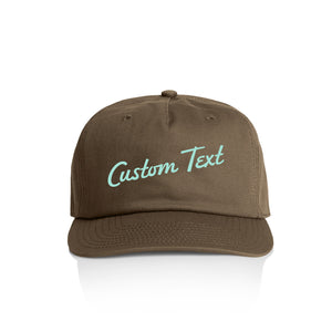 Customizable brown cap with 'Custom Text' in seaglass on a white background