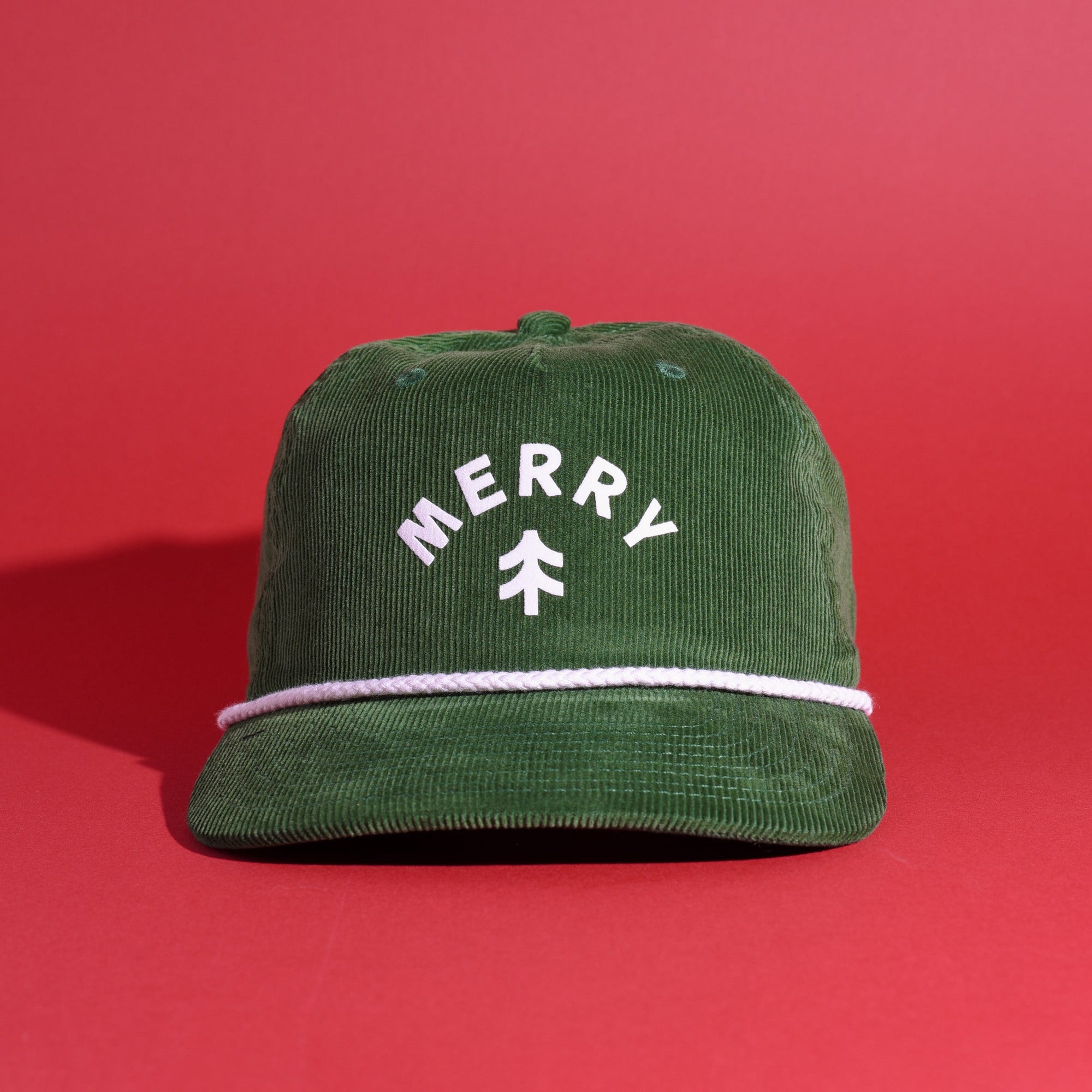 Green corduroy cap with 'Merry' text on a red background