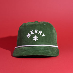 Green corduroy cap with 'Merry' text on a red background